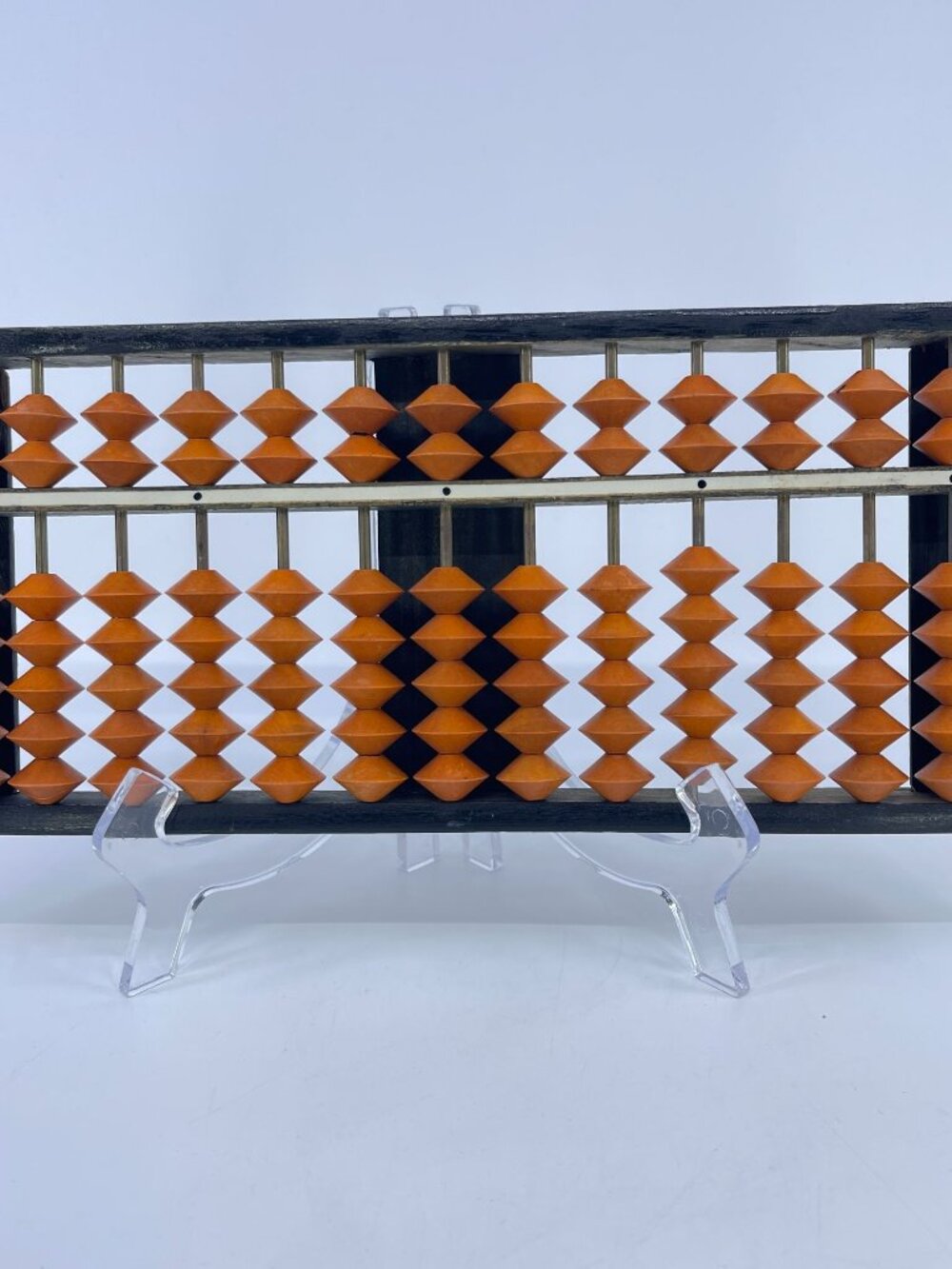 vintage japanese soroban abacus with a dark wooden frame and orange beads